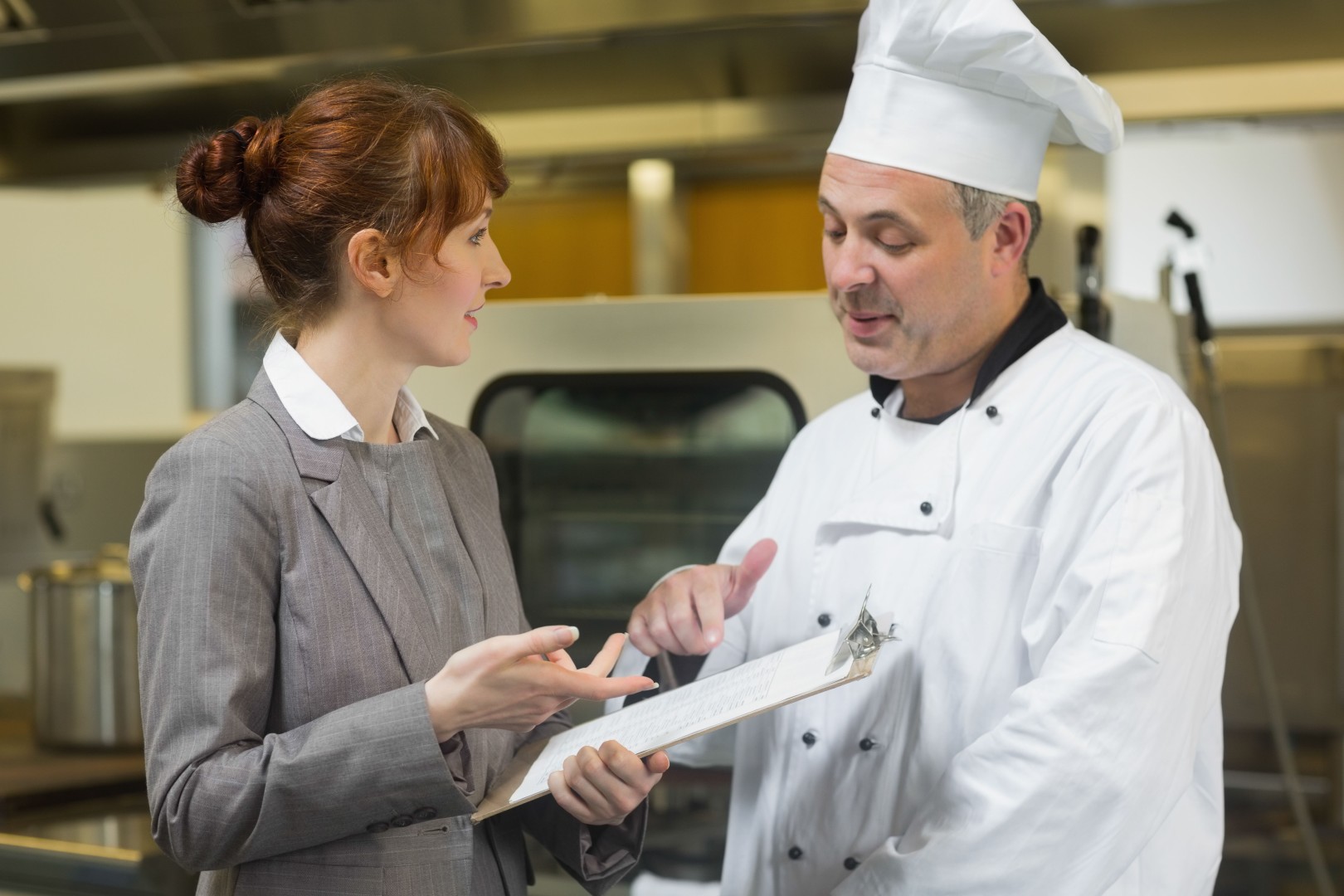 Chef Speaking To Female 